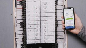 Electrician installing a modern electrical Smart panel with clean organized wiring in a residential home